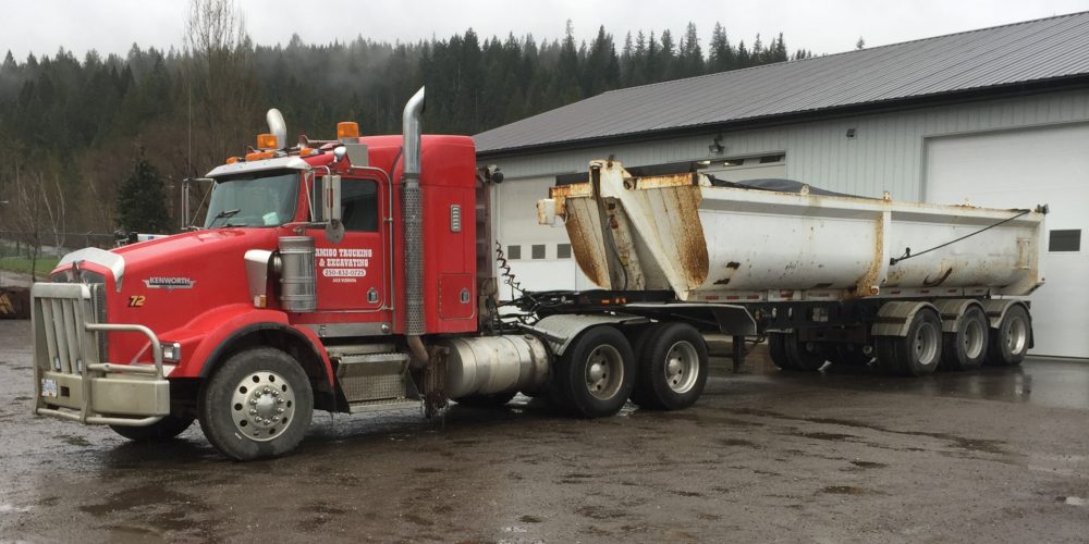Amigo Trucking & Excavating logo
